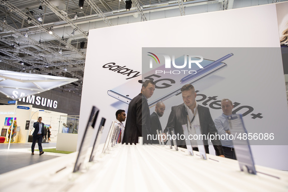 Visitors with the background of the 5G Note 10+ smartphone advertisement at Samsung boot during the international electronics and innovation...