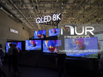Visitors with the background of Qled 8K screens at Samsung boot during the international electronics and innovation fair IFA in Berlin on Se...