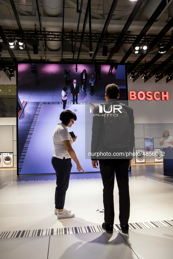 Visitors play with a virtual interactive game at Bosch boot during the international electronics and innovation fair IFA in Berlin on Septem...