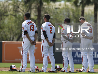 Members of the Baltimore Orioles stand for the National Anthem Saturday, March 14, 2015 before a Spring Training game against the Tampa Bay...