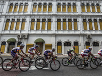 Cyclists ride pass old heritage building during final stage of Le Tour de Langkawi cycling competition in Kuala Lumpur, Malaysia on 15 March...