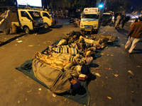 Indian farmers rests on a road in a night they came for a protest against the land acquisition bill in New Delhi on March 18,2015.Thousands...