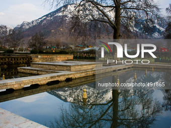 SRINAGAR, INDIAN ADMINISTERED KASHMIR, INDIA - MARCH 19: Snow capped Zabaran mountains are reflected on Shalimar Mughal garden fountain on M...