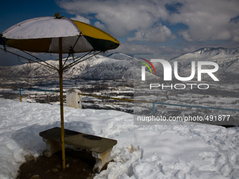 LOWER MUNDA, INDIAN ADMINISTERED KASHMIR, INDIA - MARCH 19: Snow covers an area around residential houses during a sunny on March 19, 2015 i...