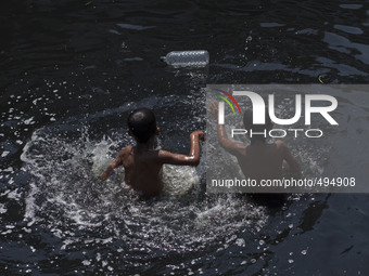 Dhaka,Bangladesh 21st March 2015;
Children are swimming in polluted water in the biologically dead river Buriganga.
The Buriganga River is o...