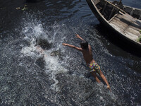 Dhaka,Bangladesh 21st March 2015;
Children are swimming in polluted water in the biologically dead river Buriganga.
The Buriganga River is o...