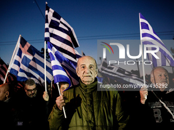 Supporter of far-right political party of Golden Dawn outside its main offices, during a gathering against immigrants in Athens, March 21, 2...