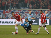 Wisla's Alan Uryga in action challenged by Cracovia's Marcin Budzinski, during the derby match between Wisla Krakow and Cracovia Krakow, a P...