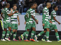 Sporting's midfielder Adrien Silva (2nd L) celebrates with team mates after scoring a goal during the Portuguese League  football match betw...