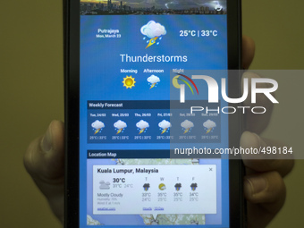 A closeup shot of a smartphone application, MyCuaca during the World Meteorological Day event in Putrajaya, Malaysia on 23 March 2015. MyCua...