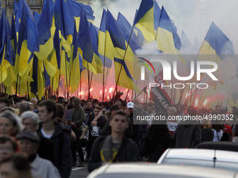 Ukrainians take part at a march to the 77th anniversary of the founding of the Ukrainian Insurgent Army in central Kiev, Ukraine, on 14 Octo...