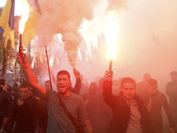 Ukrainians burn flares during a march to the 77th anniversary of the founding of the Ukrainian Insurgent Army in central Kiev, Ukraine, on 1...
