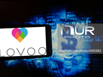 In this photo illustration taken in New York, US, on 15 October 2019 show the logo of the dating app Lovoo is seen on a screen next to an il...