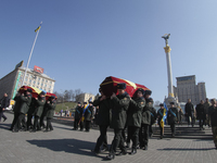 Soldiers of Honor Guard carry the coffins with remains of the Aidar battalion servicemen Vadim Shalatovsky (31) and Nazar Yakubovsky (17), w...