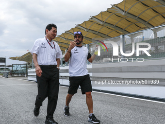 Spanish F1 driver, Fernando Alonso (R) of Mc Laren Honda  and  Honda R&D Senior Managing Officer, Yasuhisa Arai, chats
ahead of Malaysian Fo...