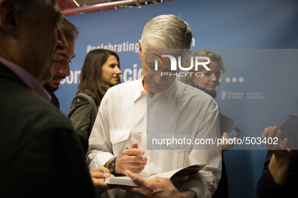 The awarded photojournalist James Nachtwey signs a book from a fan after give a conference in the office of the UNAV in Madrid, Spain, on Ma...
