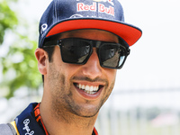 Australian F1 driver Daniel Ricciardo of Infiniti Red Bull Racing smiles as he walk at paddock area during the Malaysian Formula One Grand P...