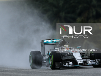 British Lewis Hamilton of  Mercedes AMG Petronas F1 Team drives on a wet track during the qualifying session of the Malaysian Formula One Gr...