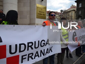 Croatian citizens protest against Swiss Franc loans in front of Croatian National Bank organized by Association Swiss Franc. They lighted 10...