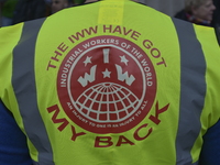 Light shining on the logo of the trade union, Industrial Workers of the World, as members campaign outside the Friends Meeting House on Eust...