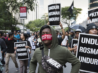 Protesters hold banners shout slogans as they march through central Kuala Lumpur during a rally in support of jailed Malaysian opposition le...