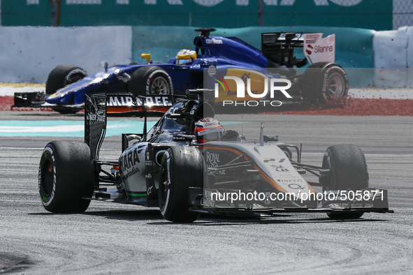 German Nico Hulkenberg (front) of Sahara Force India F1 Team competes as Swedish Marcus Ericsson (back) of Sauber F1 Team struggle in a grav...