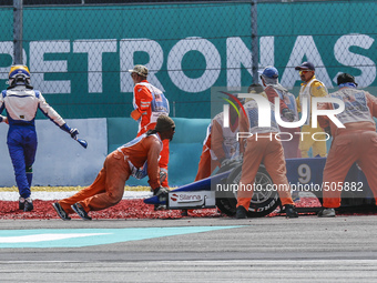 Swedish Marcus Ericsson (L) of Sauber F1 Team leave his car during the Malaysian Formula One Grand Prix at Sepang International Circuit (SIC...