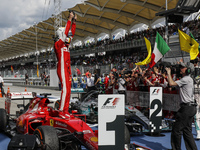 German Sebastian Vettel (L) of Scuderia Ferrari celebrates after won the Malaysian Formula One Grand Prix at Sepang International Circuit (S...