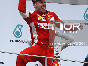 German Sebastian Vettel of Scuderia Ferrari celebrates on a podium after won the Malaysian Formula One Grand Prix at Sepang International Ci...