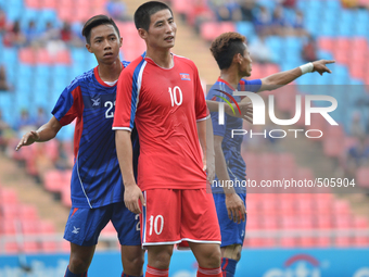 Kim Ju Song of DPR Korea (R) is closed down by Cambodia player during the AFC U-23 Championship 2016 qualifiers round at Rajamangala Stadium...