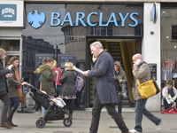 People walking outside a branch of Barclays in Camden, London, on Friday 27th March 2015. (