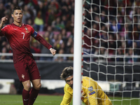 Portugal´s forward Cristiano Ronaldo (L) celebrates the team´s goal during the Portugal vs Serbia EURO 2016 qualifying football match at Luz...