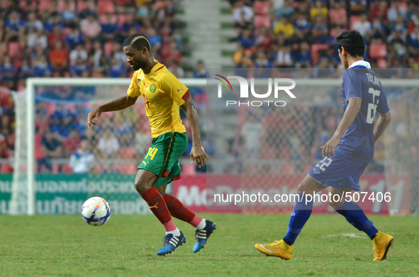Aurelien Chedjou (L) of Cameroon is closed down by Thailand player during the international friendly match between Thailand and Cemeroon at...