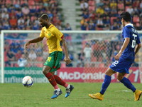 Aurelien Chedjou (L) of Cameroon is closed down by Thailand player during the international friendly match between Thailand and Cemeroon at...