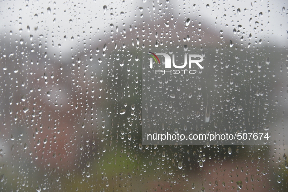 Water droplets trickling down a window in Stockport on Monday 30th March 2015. 