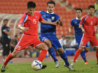 Ho Myong Chol (#15) of DPR Korea vies with Chayawat Srinawong of Thailand during the AFC U-23 Championship 2016 qualifiers round between Tha...
