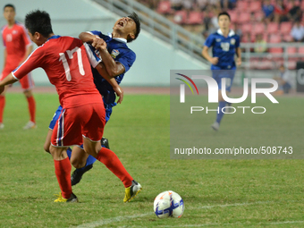 Chenrop Samphaodi (R) of Thailand is challenged by Hyon Jong Hyok of DPR Korea during the AFC U-23 Championship 2016 qualifiers round betwee...