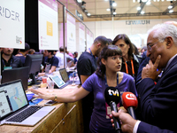 Portugal's Prime Minister Antonio Costa (R ) chats with Portuguese start-ups during his visit to the annual Web Summit technology conference...