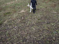 Ukrainian soldier of Azov Battalion of Ukrainian Special Forces holds crashed drone used for training controlling unmanned aerial vehicle in...
