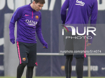 Barcelona, Spain. 2015 April 4. Leo Messi, observes the new boots of Gerard Pique during the training session of April 4 at Ciutat Esportiva...