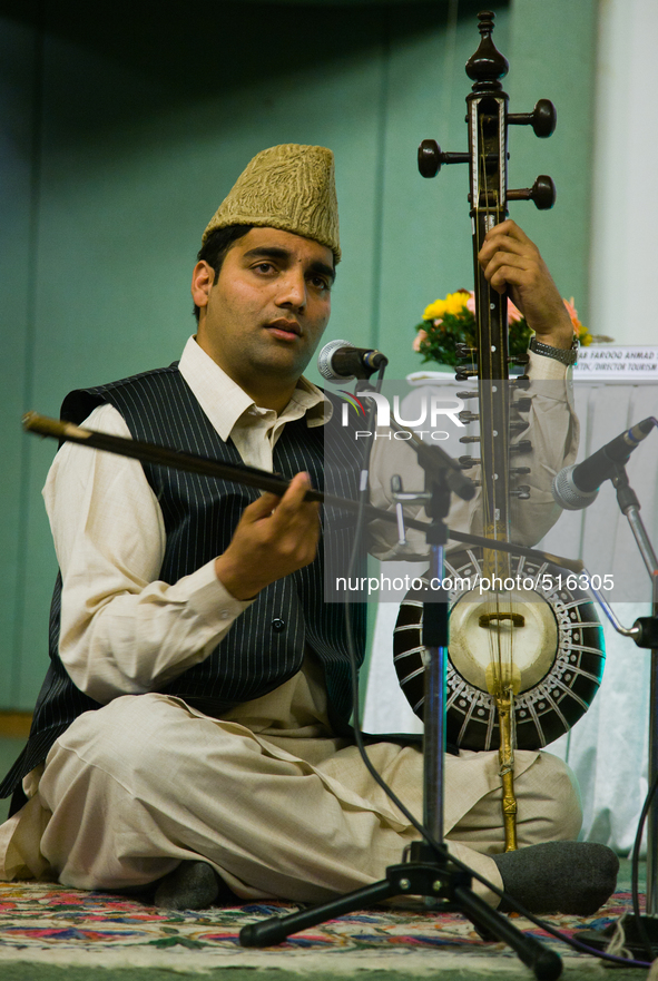 SRINAGAR, INDIAN ADMINISTERED KASHMIR, INDIA -APRIL 07: A Kashmiri singer performs with the traditional musical instrument during a function...