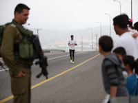 Israeli are running or participating in the marathon during an Israeli marathon in Easter near Al Sawia village in the west bank, on April 9...