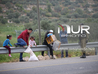Palestinians trying to pass the road during the marathon during an Israeli marathon in Easter near Al Sawia village in the west bank, on Apr...