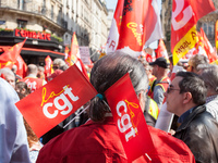 A man wearing CGT union flags in his head while looking at the march pass by in Avenue des Gobelins, in Paris, France, on April 9, 2015. 
T...