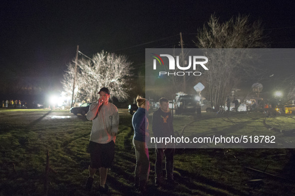 Nearby living near by looks on the search and rescue effort after a tornado struck the town of Fairdale, Illinois, United States on April 9,...