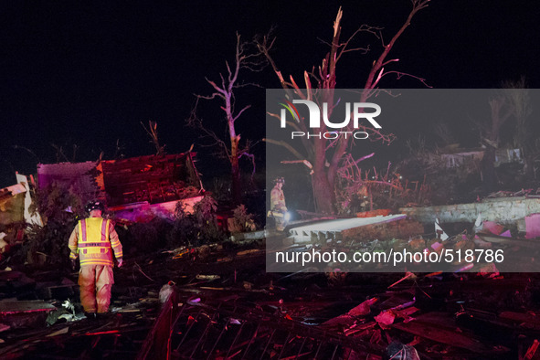 Emergency response personal searches in the rubble for survivors after a tornado struck the town of Fairdale, Illinois, United States on Apr...