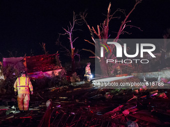 Emergency response personal searches in the rubble for survivors after a tornado struck the town of Fairdale, Illinois, United States on Apr...