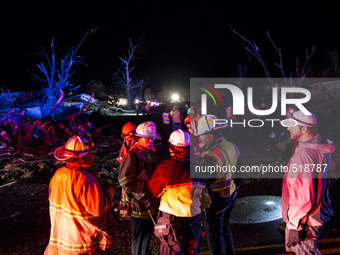 Emergency response personal gather and discusses rescue operation after a tornado struck the town of Fairdale, Illinois, United States on Ap...