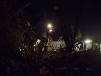 Emergency personal operating heavy machinery  searches in the rubble for survivors after a tornado struck the town of Fairdale, Illinois, Un...