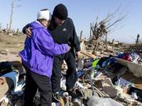 Candy Trudell searches for her belongings in the rubble after a tornado struck the town of Rochelle, IL the evening before on the Apr 10, 20...
